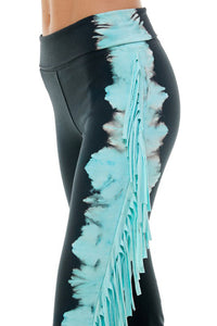 Closeup of black yoga pants with turquoise fringe accents on the legs. Made in USA by T-Party