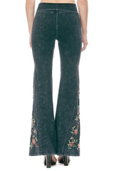 Back view of widely flared bell bottom pants with goegous multicolored floral emboiderey. Thick mineral wash yoga pants from T-Party, made in USA.